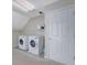 Modern laundry room with white appliances, white shelving, and plenty of storage space at 1663 Willow Way, Woodstock, GA 30188