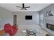 Inviting living room with a decorative fireplace and a wall-mounted television at 1663 Willow Way, Woodstock, GA 30188