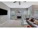 Cozy living room with a decorative fireplace, plush carpet, and ample natural light at 1663 Willow Way, Woodstock, GA 30188