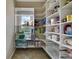 Walk-in pantry featuring bright white shelves and built-in storage with exterior light at 1663 Willow Way, Woodstock, GA 30188