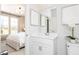 Bright bathroom with white cabinetry, modern fixtures, decorative art, and a glimpse of a bedroom at 1781 Jordan Brook Dr, Lawrenceville, GA 30043
