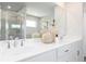 Bathroom featuring dual vanity, quartz countertops, and chrome hardware with decorative vases at 1781 Jordan Brook Dr, Lawrenceville, GA 30043