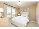 Cozy bedroom with bright light from a window and a plush white bed with decorative pillows at 1781 Jordan Brook Dr, Lawrenceville, GA 30043