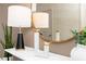 Tasteful decor accents featuring two lamps, a round mirror, and decorative birds on a marble table at 1781 Jordan Brook Dr, Lawrenceville, GA 30043