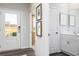 Bright entryway with a glass-paneled front door, neutral walls, and modern flooring at 1781 Jordan Brook Dr, Lawrenceville, GA 30043