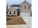 Charming two-story home showcasing a brick facade, a two-car garage, and a well manicured lawn at 1781 Jordan Brook Dr, Lawrenceville, GA 30043