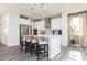 Bright kitchen features a center island with bar stool seating, pendant lighting, and stainless steel appliances at 1781 Jordan Brook Dr, Lawrenceville, GA 30043