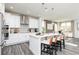 Modern kitchen with white cabinets, gray backsplash, stainless steel appliances, and a center island with seating at 1781 Jordan Brook Dr, Lawrenceville, GA 30043