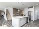 Kitchen featuring a center island, stainless steel appliances, nearby staircase, and modern finishes at 1781 Jordan Brook Dr, Lawrenceville, GA 30043