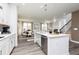 Beautiful open kitchen featuring a center island, stainless dishwasher, and open view of dining and living area at 1781 Jordan Brook Dr, Lawrenceville, GA 30043