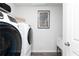 Convenient laundry room with a washer and dryer, utility sink, and ample storage space at 1781 Jordan Brook Dr, Lawrenceville, GA 30043