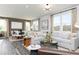 Spacious living room featuring modern decor, large windows, and an adjacent dining area at 1781 Jordan Brook Dr, Lawrenceville, GA 30043