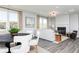 Bright living room featuring a modern fireplace, stylish furnishings, and large windows at 1781 Jordan Brook Dr, Lawrenceville, GA 30043