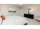 Relaxing main bedroom featuring large black dresser with round mirror and modern, neutral decor at 1781 Jordan Brook Dr, Lawrenceville, GA 30043