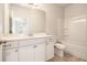 Well-lit bathroom featuring a single vanity, tile floors, and shower-tub combo at 3919 Shelleydale Dr, Powder Springs, GA 30127