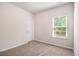 Clean bedroom with neutral walls, carpeted floors, and a bright window at 3919 Shelleydale Dr, Powder Springs, GA 30127