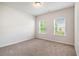 Well lit bedroom with carpeted floor and natural light from the windows at 3919 Shelleydale Dr, Powder Springs, GA 30127