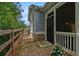 Side exterior view of home shows stylish design with screen porch, fence, and landscaped surroundings at 3919 Shelleydale Dr, Powder Springs, GA 30127