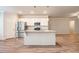 Bright kitchen featuring white cabinets, granite countertops, and stainless steel refrigerator at 3919 Shelleydale Dr, Powder Springs, GA 30127