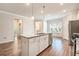 Open-concept kitchen with island featuring granite countertops and stainless appliances at 3919 Shelleydale Dr, Powder Springs, GA 30127