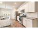 Well-lit kitchen with white cabinets, granite countertops, and stainless steel appliances at 3919 Shelleydale Dr, Powder Springs, GA 30127