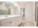 This bathroom offers a double sink vanity, tile floors, and walk-in shower at 3919 Shelleydale Dr, Powder Springs, GA 30127
