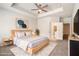 Bright main bedroom featuring a ceiling fan, carpeted floors, and ensuite bath access at 3919 Shelleydale Dr, Powder Springs, GA 30127