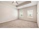 Bright bedroom with tray ceiling, neutral carpet, and large windows at 3919 Shelleydale Dr, Powder Springs, GA 30127