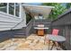 Back patio with a built-in grill, outdoor seating, and stylish stone flooring, ideal for gatherings at 574 Chicasaw Ne Dr, Marietta, GA 30060