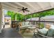 Inviting back porch with ceiling fan, outdoor seating, and view of the private, wooded backyard at 574 Chicasaw Ne Dr, Marietta, GA 30060