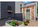 Charming backyard space with a garden, brick wall, shingle siding, and stylish green door at 574 Chicasaw Ne Dr, Marietta, GA 30060