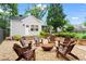 Inviting backyard seating area with chairs and a fire pit for relaxing and entertaining at 574 Chicasaw Ne Dr, Marietta, GA 30060