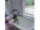 Luxurious soaking tub featuring modern fixtures, a window view, and sleek design at 574 Chicasaw Ne Dr, Marietta, GA 30060