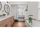 Elegant bathroom featuring dual sinks, a soaking tub and a separate walk-in shower at 574 Chicasaw Ne Dr, Marietta, GA 30060