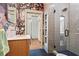 Stylish bathroom featuring floral wallpaper, a glass enclosed shower, and a vanity with counter space at 574 Chicasaw Ne Dr, Marietta, GA 30060