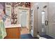 Unique bathroom with floral wallpaper, walk-in shower, and vanity with marble countertop at 574 Chicasaw Ne Dr, Marietta, GA 30060