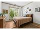 Cozy bedroom with a comfortable bed, hardwood flooring and natural light at 574 Chicasaw Ne Dr, Marietta, GA 30060