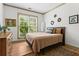 Cozy bedroom featuring a comfortable bed, dresser, and natural light from a window at 574 Chicasaw Ne Dr, Marietta, GA 30060