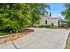 House exterior shows a driveway and lush landscaping and trees at 574 Chicasaw Ne Dr, Marietta, GA 30060