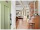 Inviting foyer with hardwood floors, vintage piano, stylish decor, and a view of the living room at 574 Chicasaw Ne Dr, Marietta, GA 30060