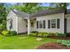 Inviting front exterior with gray siding, black shutters, green front door, and manicured landscaping at 574 Chicasaw Ne Dr, Marietta, GA 30060