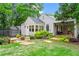 Charming home with a lush front yard, stone walkway, beautiful landscaping, and cozy front porch at 574 Chicasaw Ne Dr, Marietta, GA 30060
