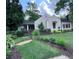 Charming home featuring a well-manicured lawn, wood fence, and beautiful landscaping at 574 Chicasaw Ne Dr, Marietta, GA 30060
