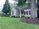 Landscaped front yard of a charming home with lush green lawn and mature trees at 574 Chicasaw Ne Dr, Marietta, GA 30060