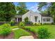 Charming home with stone walkway, lush landscaping, gray picket fence, and inviting curb appeal at 574 Chicasaw Ne Dr, Marietta, GA 30060
