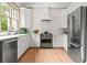 Well-equipped kitchen with stainless steel appliances, white cabinets, and a vintage green oven range at 574 Chicasaw Ne Dr, Marietta, GA 30060