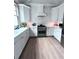 Modern kitchen with white cabinets, stainless steel appliances, and hardwood floors at 574 Chicasaw Ne Dr, Marietta, GA 30060
