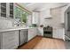 Bright, modern kitchen features white cabinets, stainless appliances, and ample natural light from large window at 574 Chicasaw Ne Dr, Marietta, GA 30060