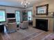 Inviting living room with fireplace, bookshelves, and neutral toned area rug at 574 Chicasaw Ne Dr, Marietta, GA 30060