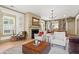 Elegant living room with fireplace, hardwood floors and open to the dining room at 574 Chicasaw Ne Dr, Marietta, GA 30060